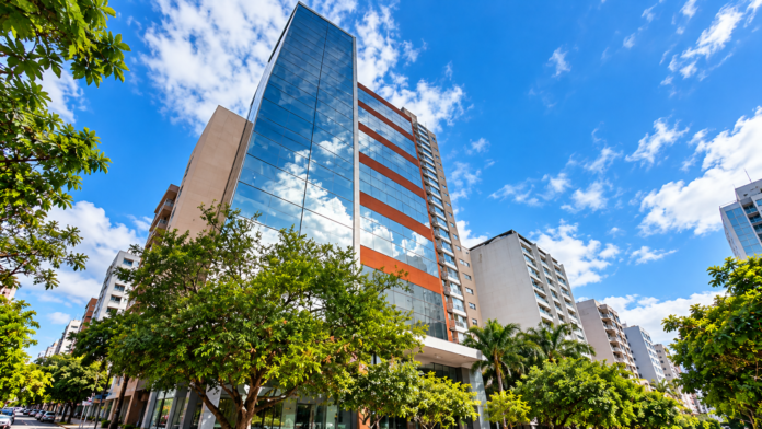 Glass Tower Among Urban Greenery
